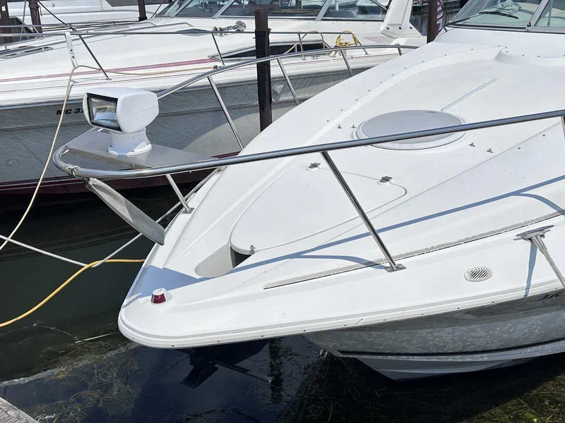 Slide: The Image of 1998 Cruisers Yachts 3075 Rogue docked, showcasing sleek white design and modern features. - 1