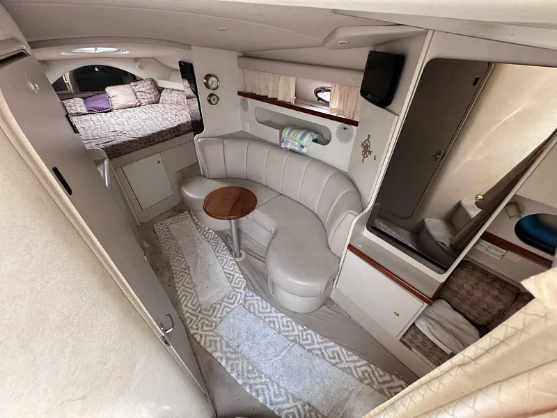 Slide: The Image of 1998 Cruisers Yachts 3075 Rogue interior with cozy seating and sleeping area. - 10