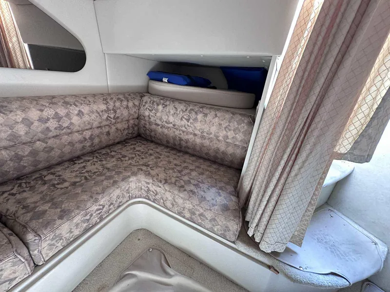Slide: The Image of Interior of 1998 Cruisers Yachts 3075 Rogue with patterned seating and curtains. - 13