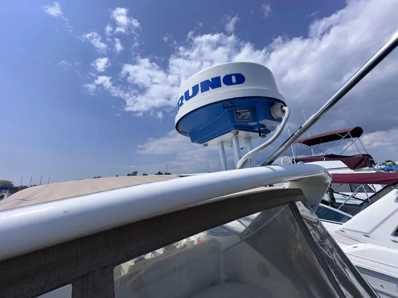 Slide: The Image of Radar equipment on a 1998 Cruisers Yachts 3075 Rogue under a partly cloudy sky. - 21