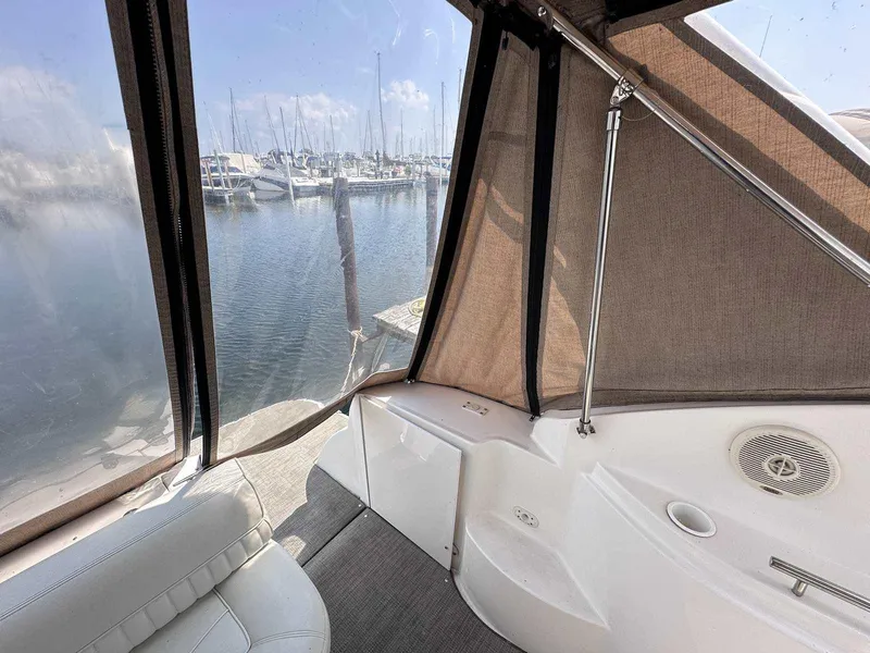 Slide: The Image of 1998 Cruisers Yachts 3075 Rogue interior with marina view through canvas enclosure. - 4