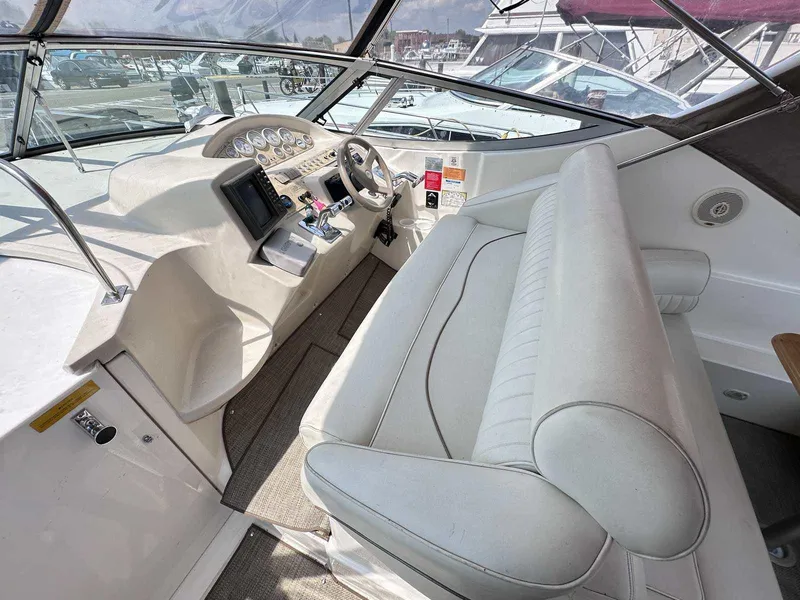 Slide: The Image of 1998 Cruisers Yachts 3075 Rogue cockpit with steering wheel and control panel. - 6