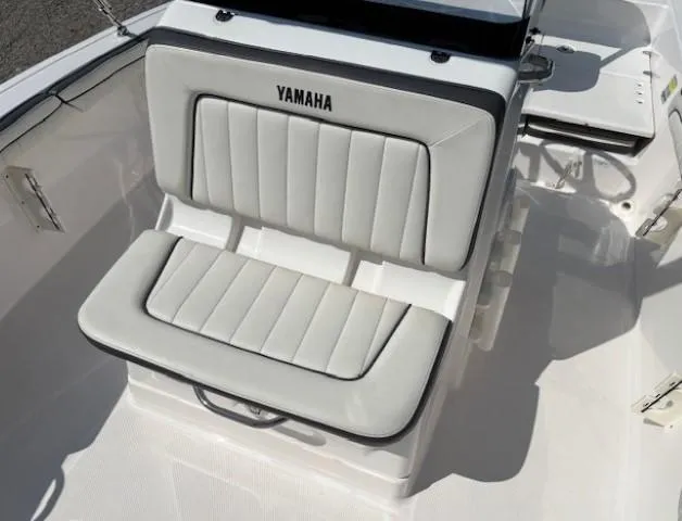Slide: The Image of 2017 Yamaha Boats 190 FSH Deluxe seat with white cushioned upholstery. - 14