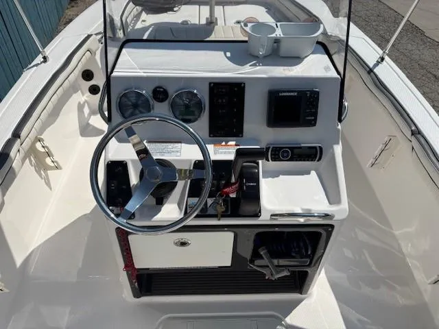 Slide: The Image of 2017 Yamaha Boats 190 FSH Deluxe dashboard with steering wheel and controls. - 19