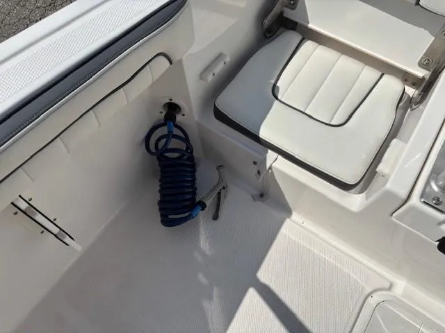 Slide: The Image of 2017 Yamaha Boats 190 FSH Deluxe interior with seating and coiled hose. - 22