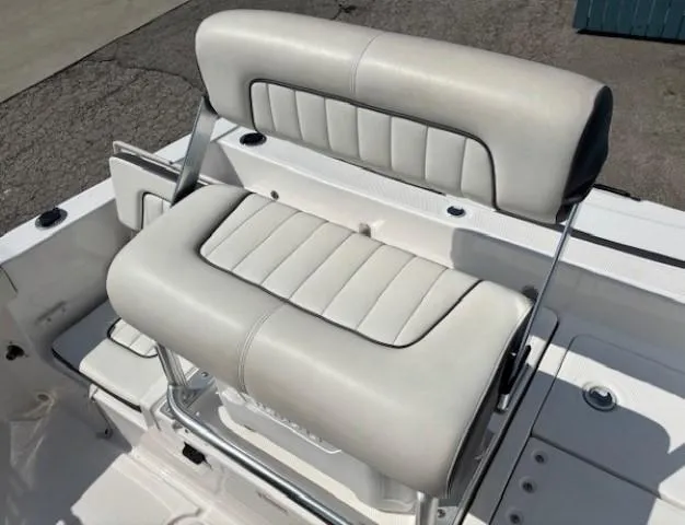 Slide: The Image of 2017 Yamaha Boats 190 FSH Deluxe seat, white upholstery, sleek design, outdoor setting. - 23
