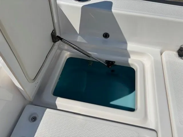 Slide: The Image of Open storage compartment on a 2017 Yamaha Boats 190 FSH Deluxe. - 27