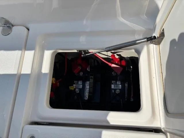 Slide: The Image of Battery compartment of 2017 Yamaha Boats 190 FSH Deluxe, showing dual batteries and wiring. - 28