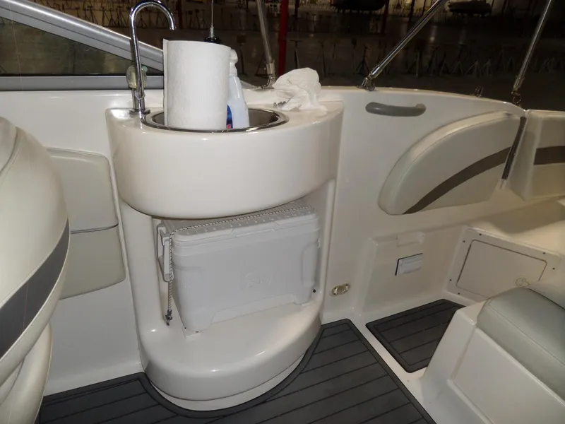 Slide: The Image of 2006 Maxum 2400 SR3 boat interior with sink and cooler storage. - 14