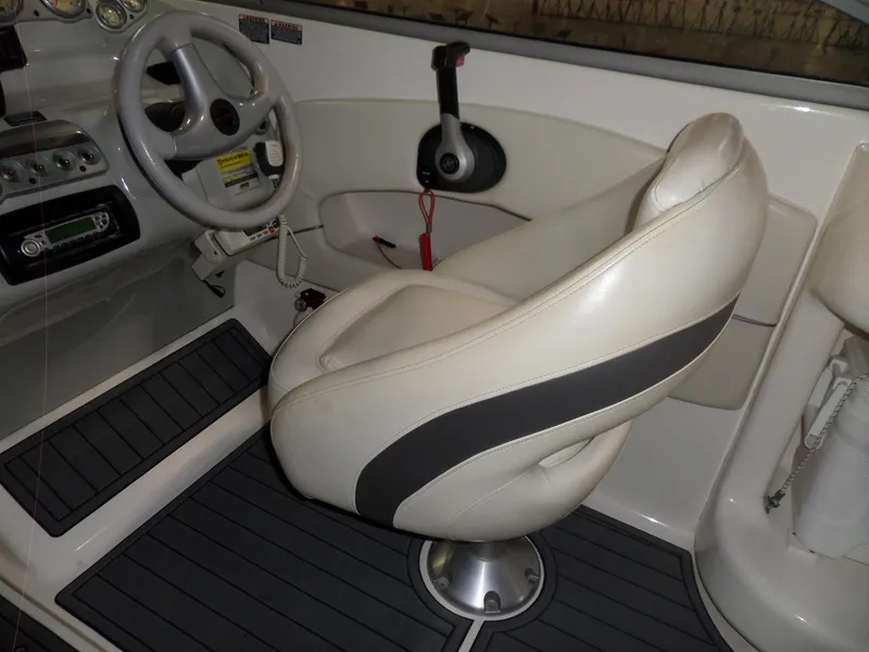Slide: The Image of Interior of 2006 Maxum 2400 SR3 boat with steering wheel and captain's chair. - 15
