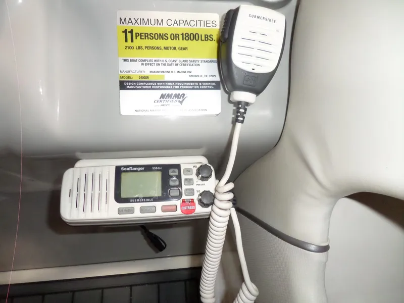 Slide: The Image of 2006 Maxum 2400 SR3 boat capacity label and SeaRanger VHF radio. - 20