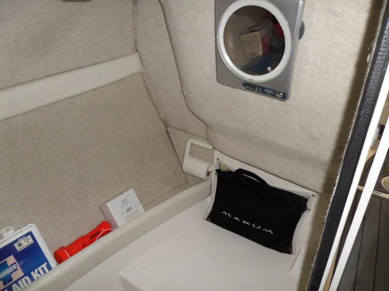 Slide: The Image of Interior of 2006 Maxum 2400 SR3 boat with first aid kit and storage. - 28
