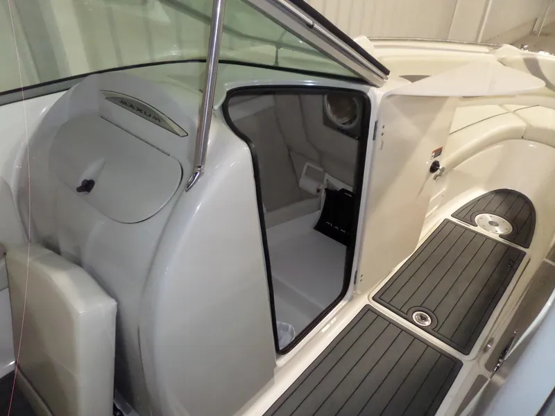 Slide: The Image of 2006 Maxum 2400 SR3 boat interior with open cabin door and seating area. - 31