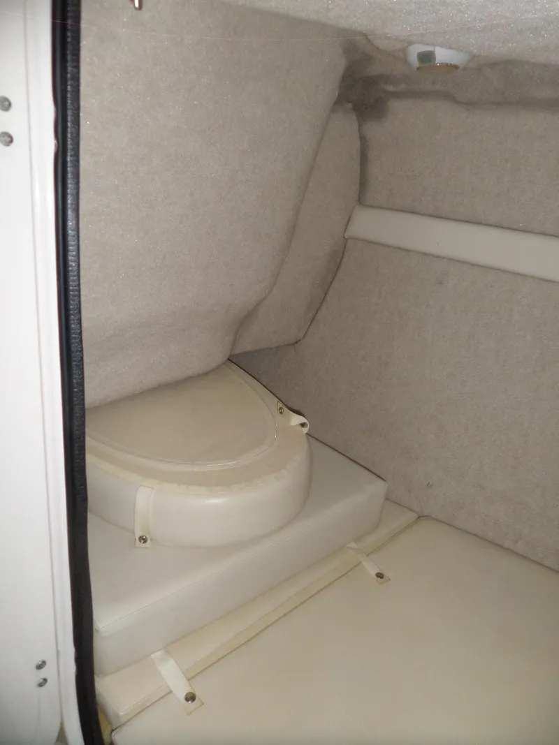 Slide: The Image of 2006 Maxum 2400 SR3 boat interior with compact toilet and beige upholstery. - 32