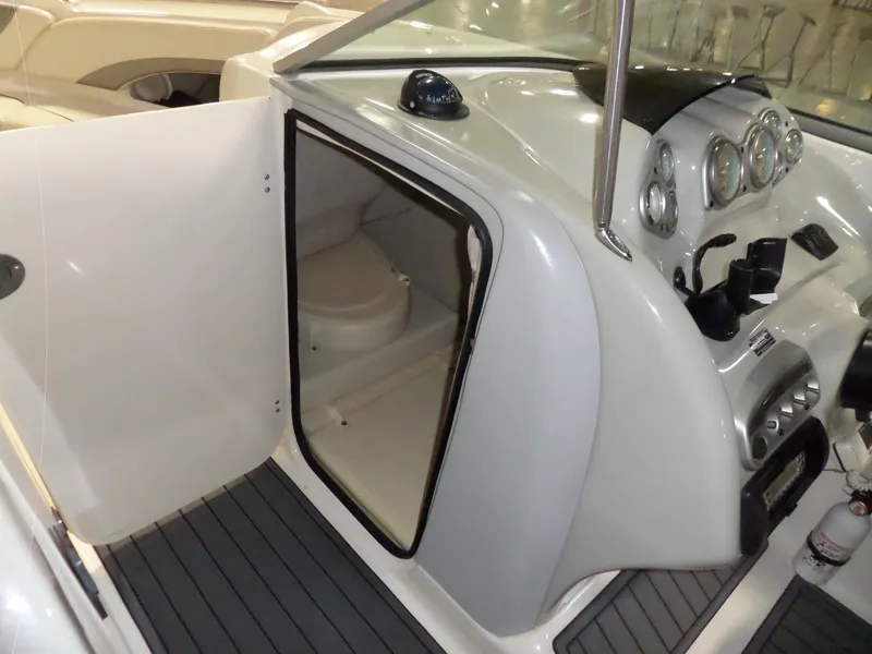 Slide: The Image of 2006 Maxum 2400 SR3 boat interior with helm and cabin door open. - 34