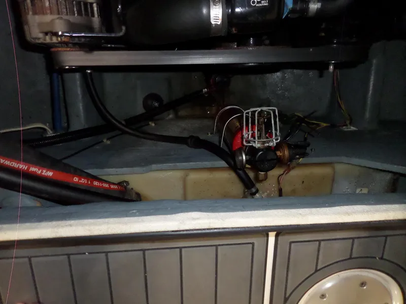 Slide: The Image of Engine compartment of a 2006 Maxum 2400 SR3 boat, showing hoses and components. - 38