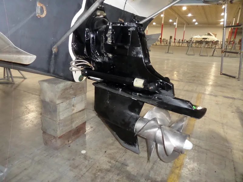 Slide: The Image of 2006 Maxum 2400 SR3 boat propeller and stern drive in a warehouse setting. - 4