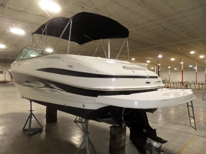 Slide: The Image of 2006 Maxum 2400 SR3 boat with black canopy in indoor storage facility. - 5