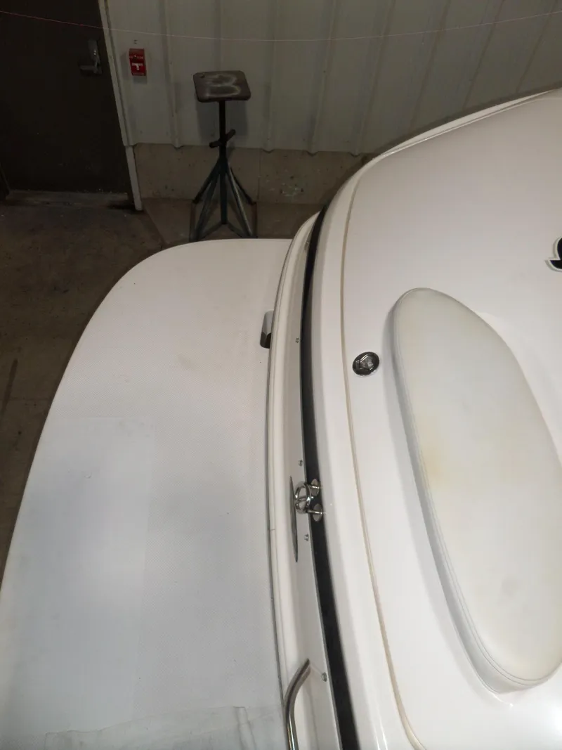 Slide: The Image of 2006 Maxum 2400 SR3 boat interior detail in a garage setting. - 8