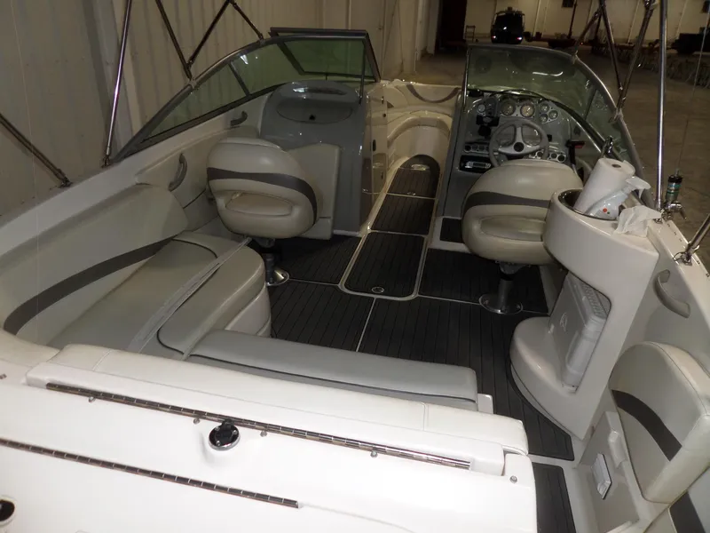 Slide: The Image of 2006 Maxum 2400 SR3 boat interior with seating and dashboard, showcasing sleek design and comfort. - 9