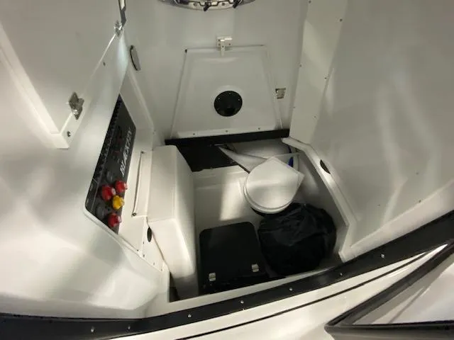 Slide: The Image of Interior of 2022 Blackfin 272 CC boat, featuring storage and control panel. - 13