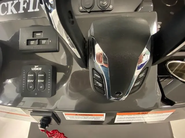 Slide: The Image of Control panel of a 2022 Blackfin 272 CC boat with throttle and switches. - 14
