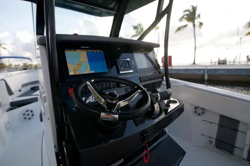 Slide: The Image of 2022 Blackfin 272 CC boat dashboard with navigation screens and steering wheel. - 4
