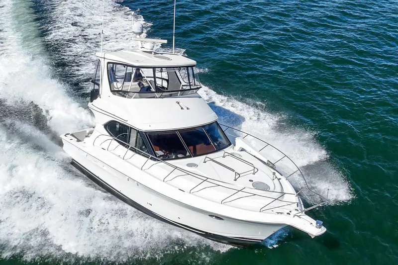 The Image of 2004 Silverton 38 Convertible yacht cruising on open water. - 0