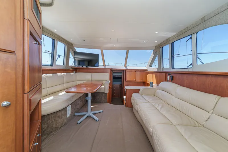 Slide: The Image of Luxurious interior of 2004 Silverton 38 Convertible yacht with beige leather seating. - 10