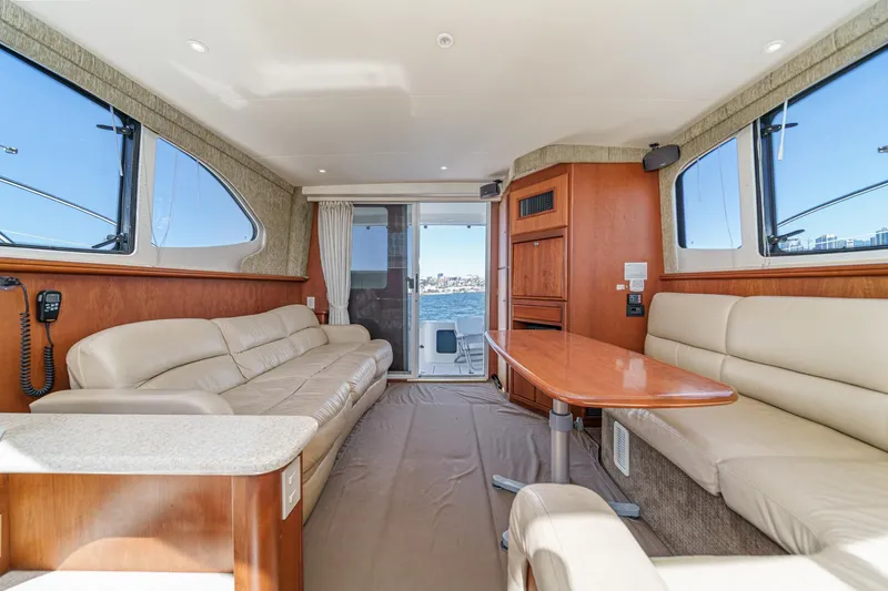 Slide: The Image of Luxurious interior of 2004 Silverton 38 Convertible yacht with beige leather seating. - 11