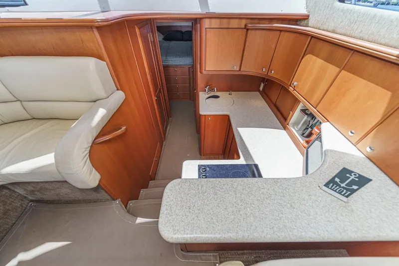 Slide: The Image of Interior of 2004 Silverton 38 Convertible yacht with kitchen and seating area. - 14