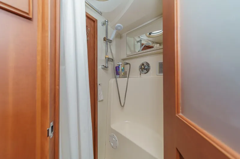 Slide: The Image of Bathroom interior of 2004 Silverton 38 Convertible yacht with shower and wooden door. - 18