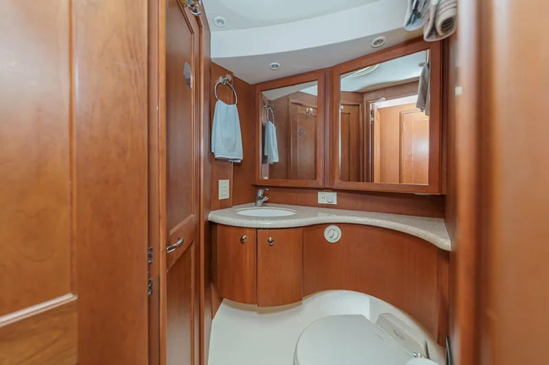 Slide: The Image of Luxurious bathroom interior of 2004 Silverton 38 Convertible yacht with wood cabinetry. - 19