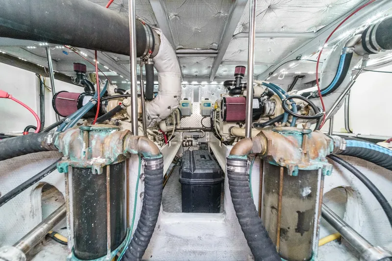 Slide: The Image of Engine room of a 2004 Silverton 38 Convertible yacht, showcasing dual engines and piping. - 23