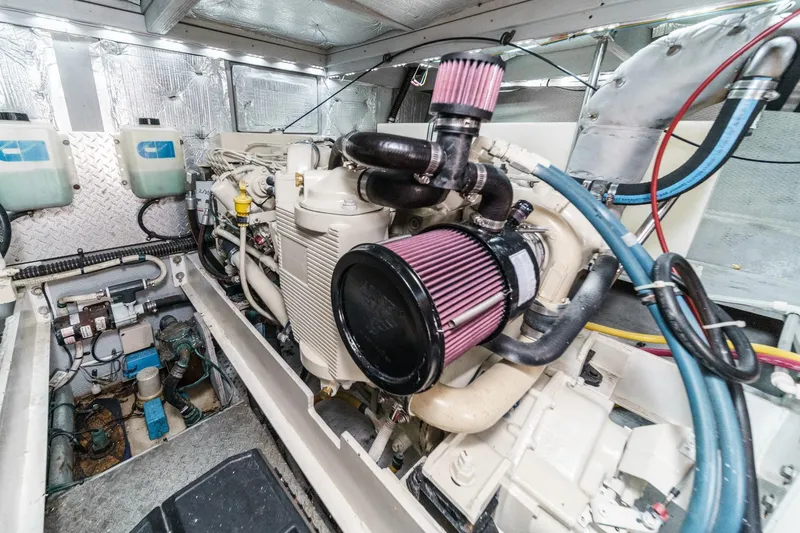Slide: The Image of Engine room of a 2004 Silverton 38 Convertible yacht, showcasing detailed machinery. - 24