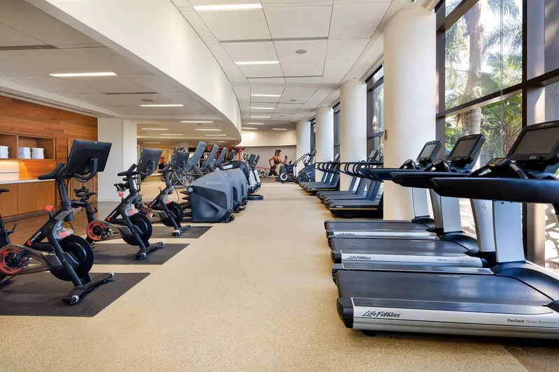 Slide: The Image of Modern gym with treadmills and exercise bikes in a spacious, well-lit room. - 27