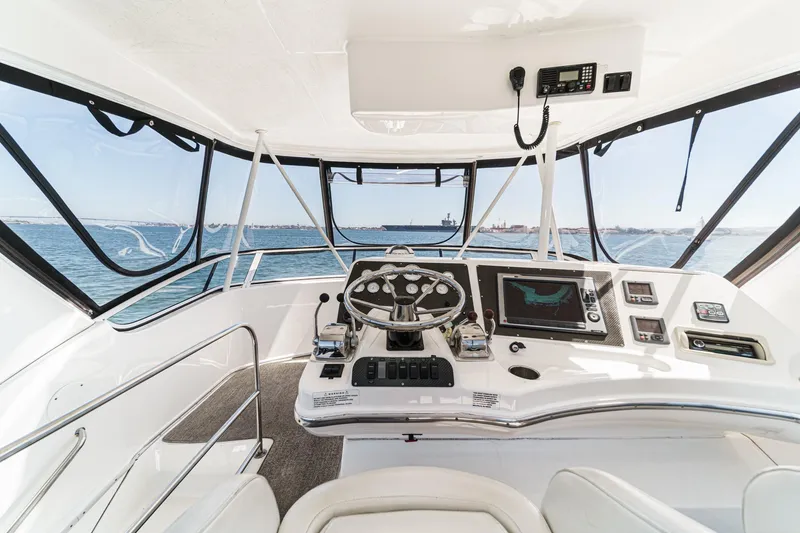 Slide: The Image of 2004 Silverton 38 Convertible yacht helm with ocean view and navigation equipment. - 4