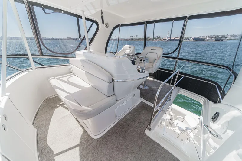 Slide: The Image of 2004 Silverton 38 Convertible yacht interior with helm, seating, and ocean view. - 5