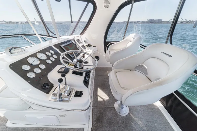 Slide: The Image of 2004 Silverton 38 Convertible yacht helm with steering wheel and control panel. - 6
