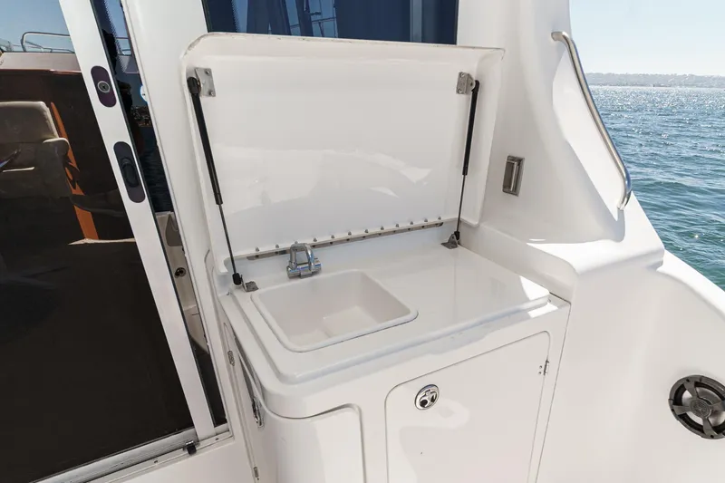 Slide: The Image of 2004 Silverton 38 Convertible yacht sink area with ocean view. - 9