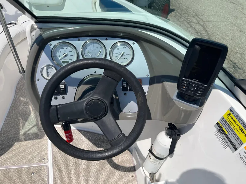 Slide: The Image of 2013 Rinker Captiva 186 BR FS OB dashboard with steering wheel and Garmin device. - 11