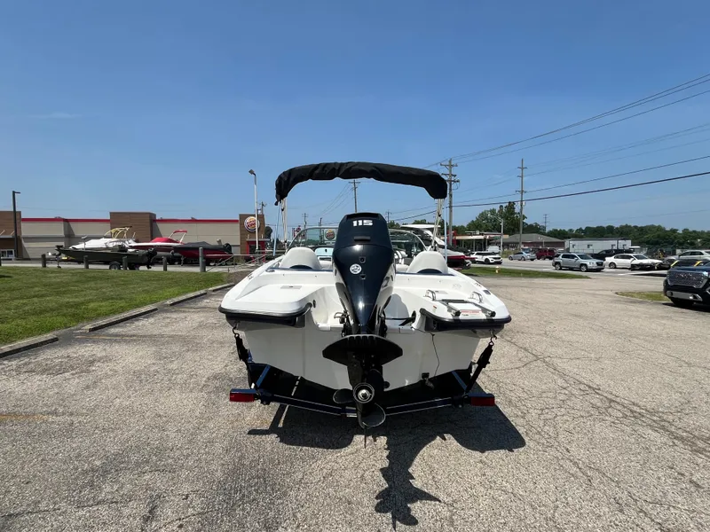 Slide: The Image of 2013 Rinker Captiva 186 BR FS OB boat with outboard motor, parked outdoors. - 2