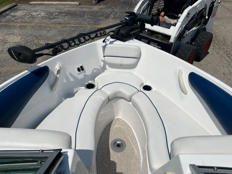 Slide: The Image of 2013 Rinker Captiva 186 BR FS OB boat interior with seating and trolling motor. - 6