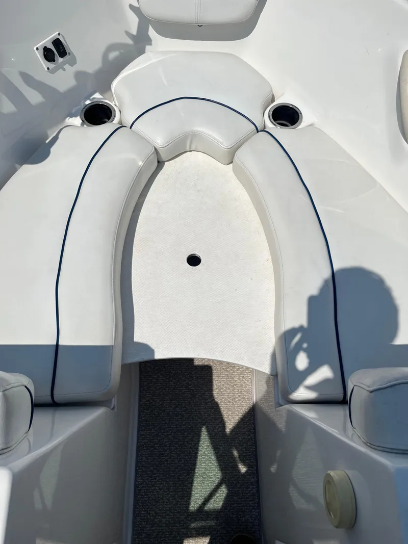 Slide: The Image of 2013 Rinker Captiva 186 BR FS OB boat interior with white cushioned seating. - 7