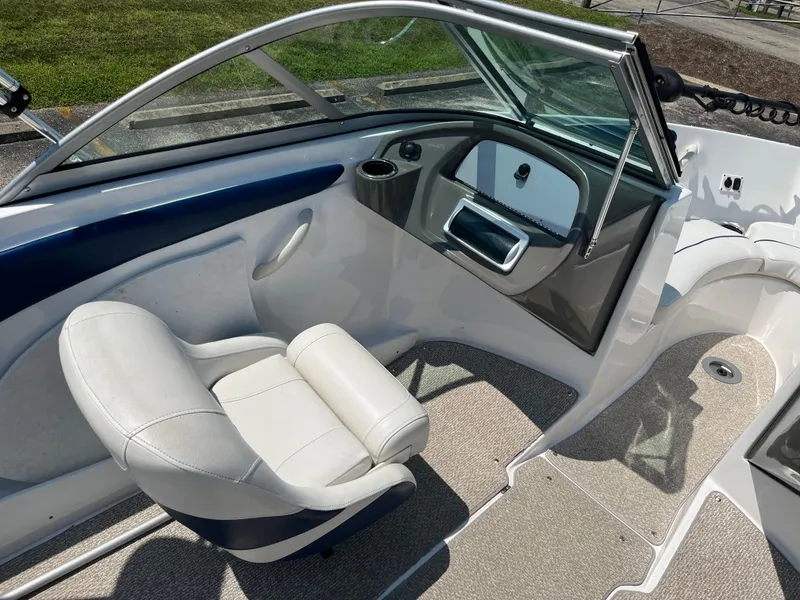 Slide: The Image of Interior of 2013 Rinker Captiva 186 BR FS OB boat with white seating and dashboard. - 8