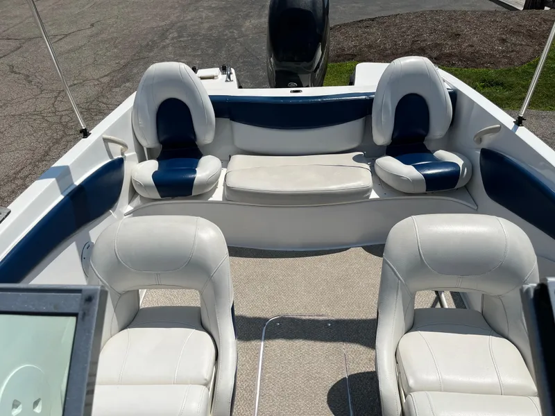 Slide: The Image of 2013 Rinker Captiva 186 BR FS OB boat interior with white and blue seating. - 9