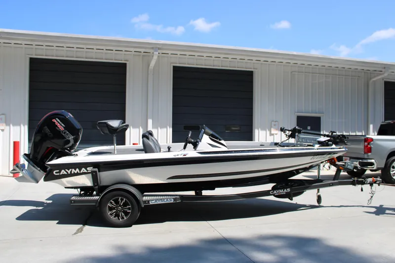 The Image of 2022 Caymas CX 18 SS boat on trailer, parked outside a garage. - 1