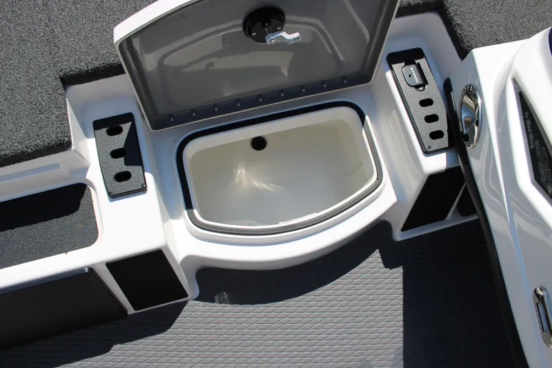 Slide: The Image of 2022 Caymas CX 18 SS boat storage compartment with open lid and cup holders. - 10