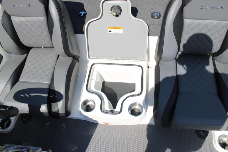Slide: The Image of 2022 Caymas CX 18 SS boat interior with gray seats and storage compartment. - 11
