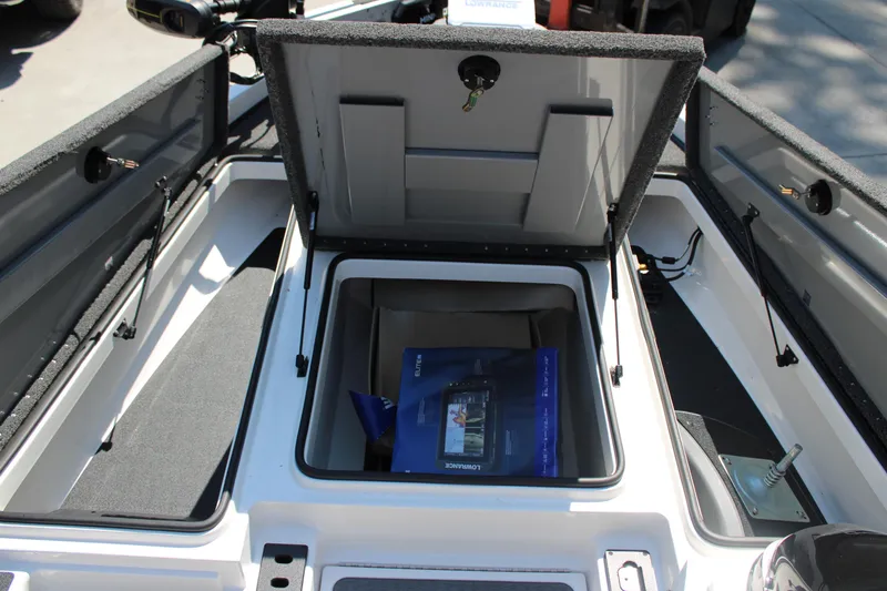 Slide: The Image of 2022 Caymas CX 18 SS boat storage compartments open, showcasing interior space and equipment. - 6